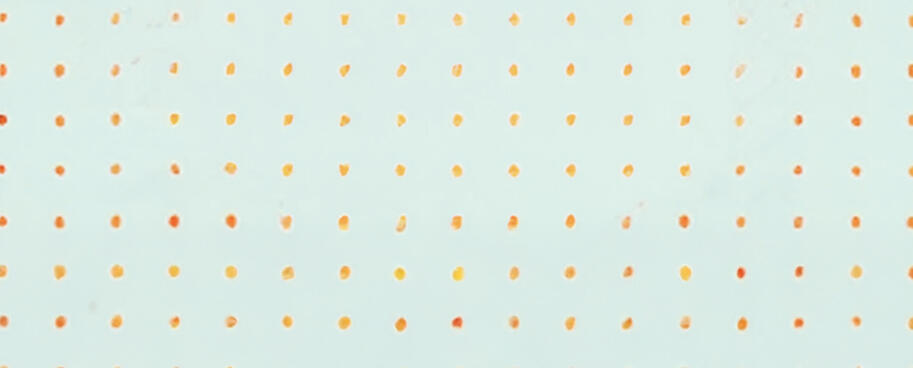 image of a woman sitting, surrounded by colorful paintings